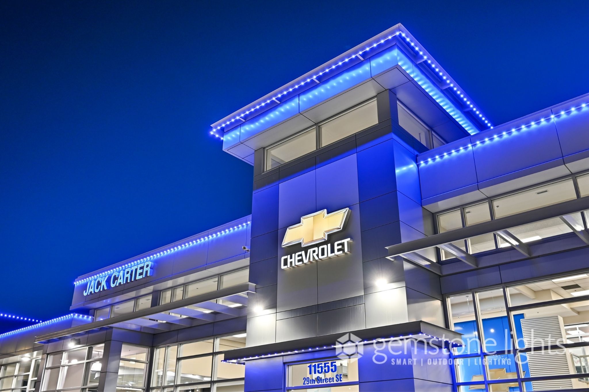 Gemstone Lights commercial reference showing blue architectural lighting on a dealership