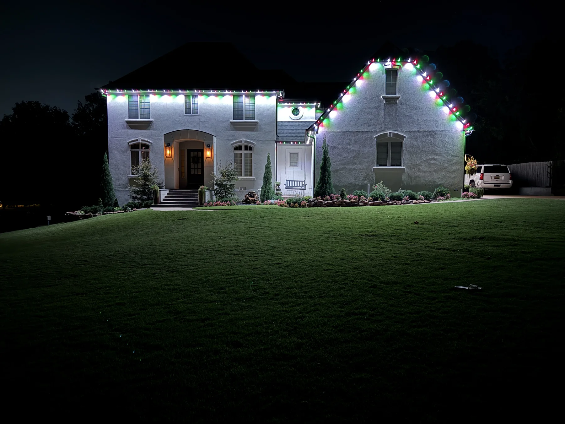 A completed home displaying red, green, and white lighting