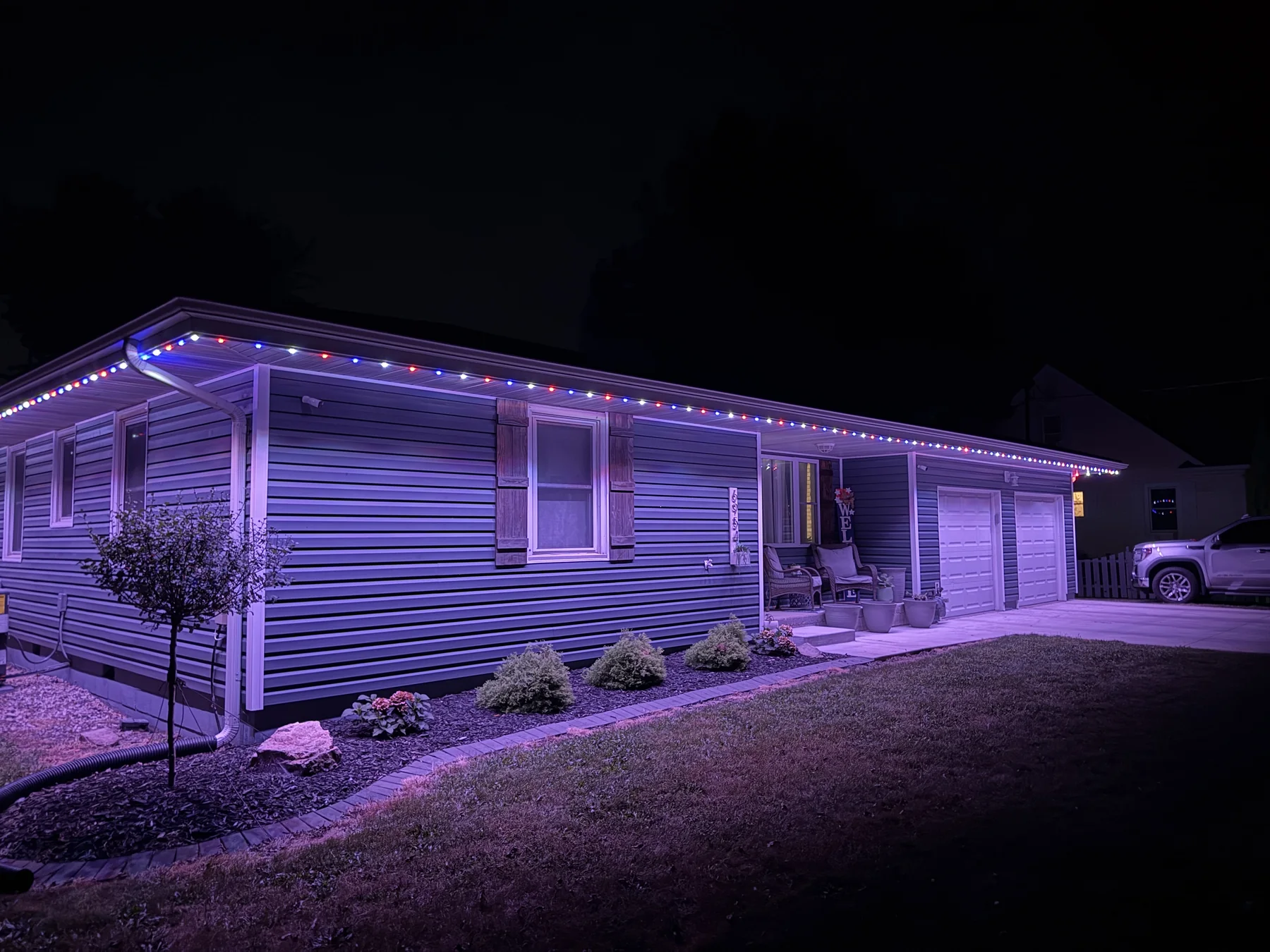 A completed roofline lighting project displaying red, white, and blue